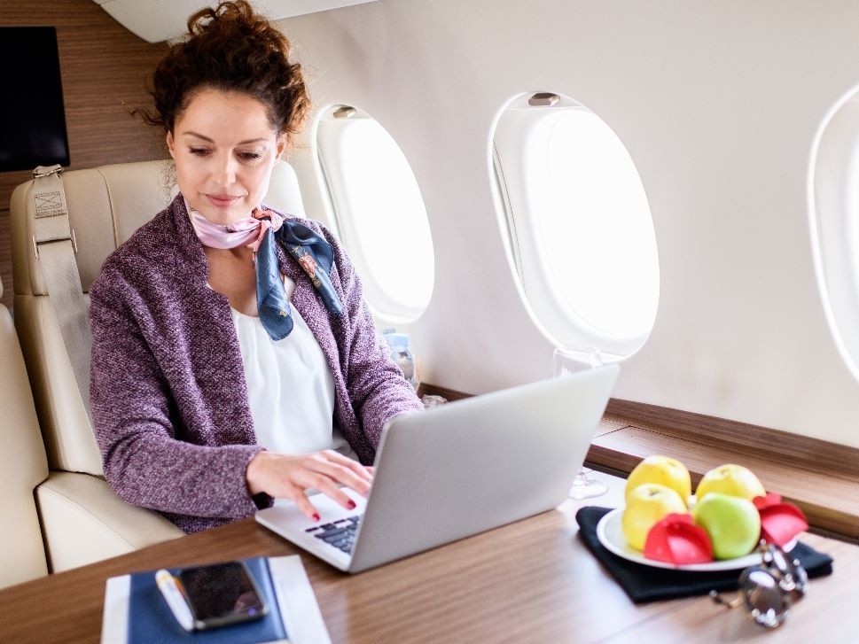 Businesswoman Enjoys Private Jet Cabin Connectivity