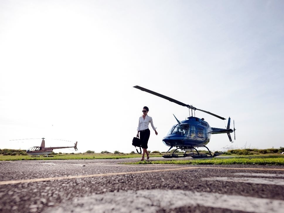 Arriving at a business meeting in a corporate helicopter