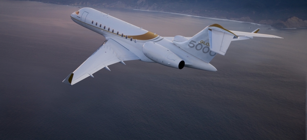 Global 5000 flying above mountains