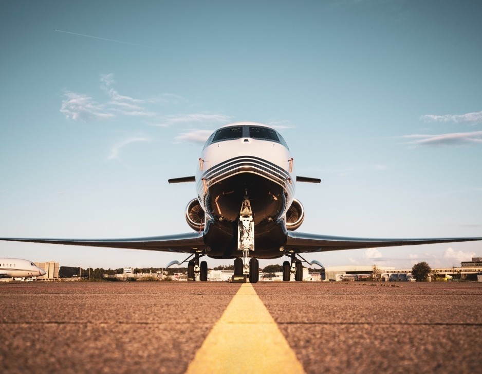 Front view of a Gulfstream business jet parked on an airport ramp