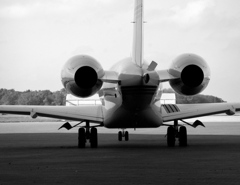 Rear view of a private jet parked on the airport ramp