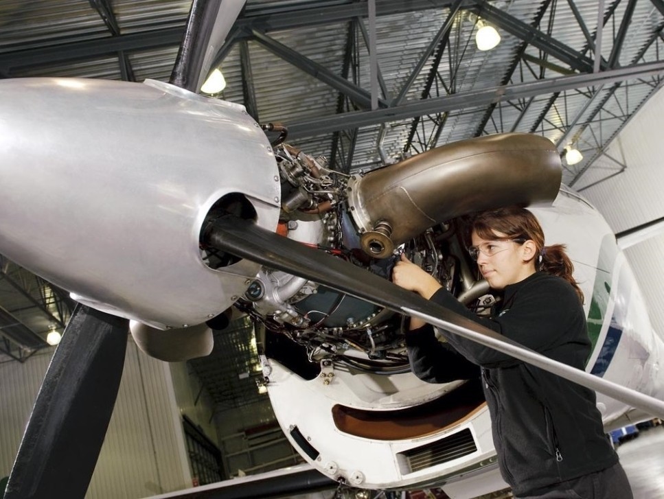 Young Pratt & Whitney mechanic works on a PT6A turboprop engine