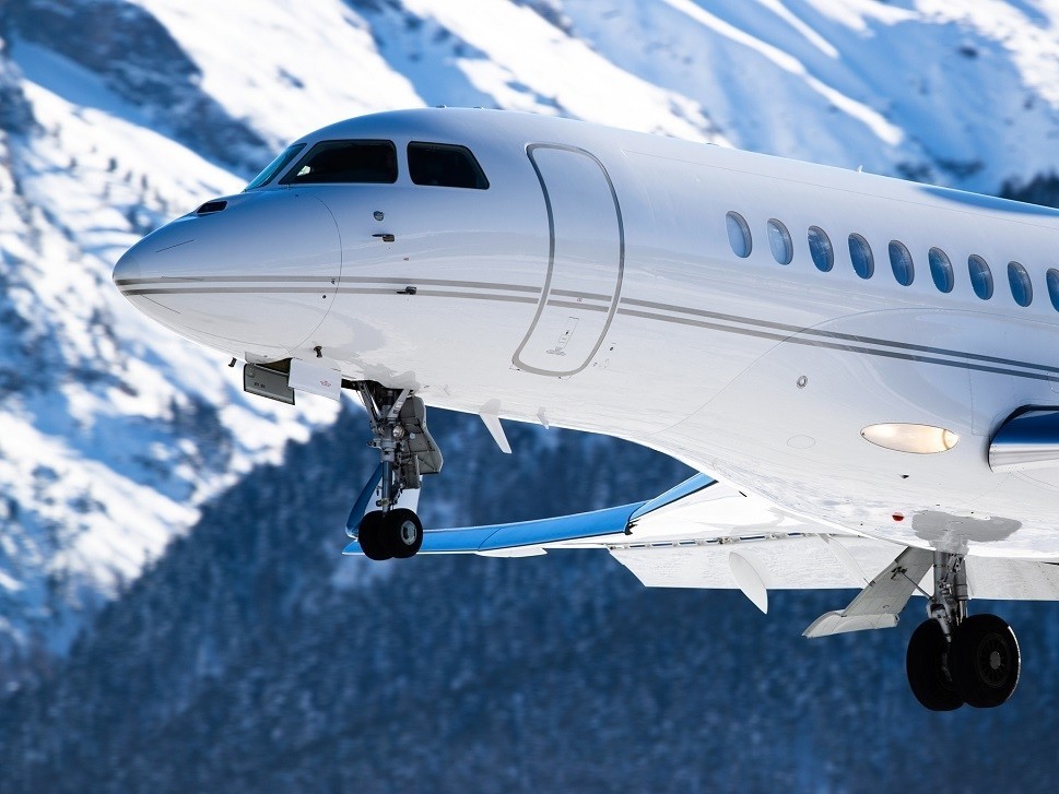 A Dassault Falcon business jet landing at a mountain airport