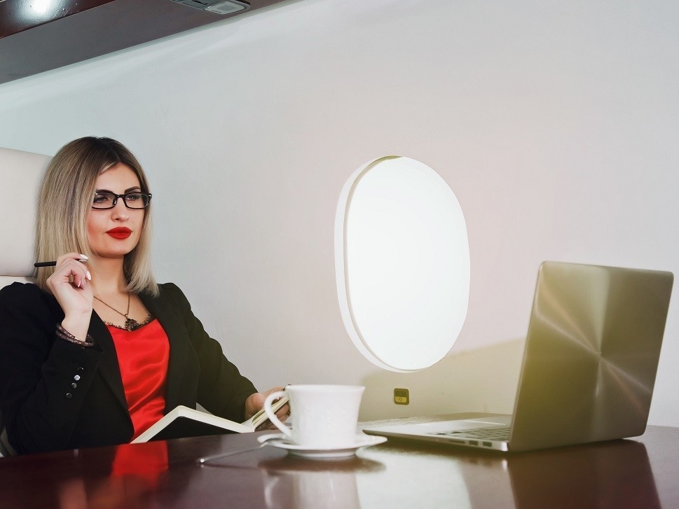 A savvy executive in the cabin of a private jet