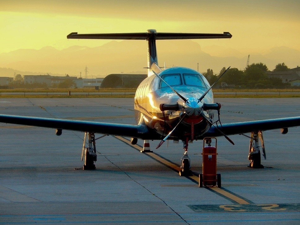 Pilatus PC-12 NG turboprop at a regional airport at sunset