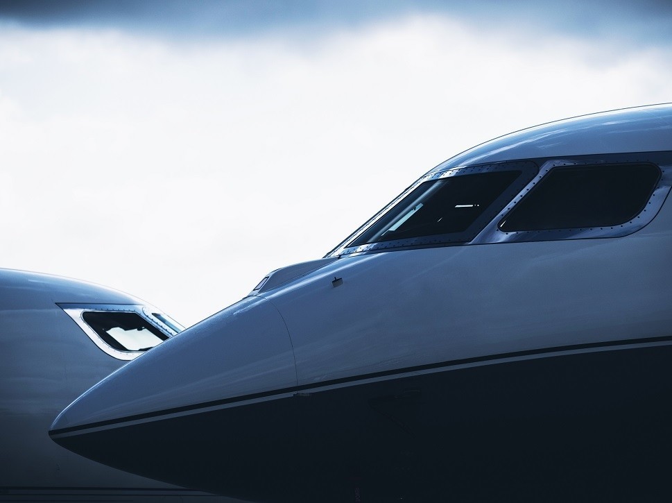 Private jet nose cones overlap on airport ramp