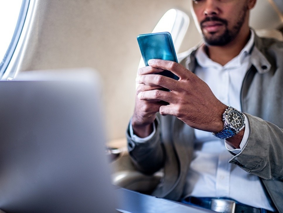 Young executive at work aboard a private jet