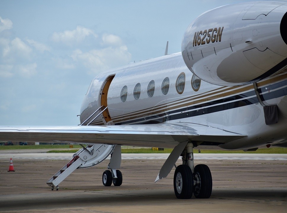 Gulfstream private jet with airstairs open for passenger pick-up
