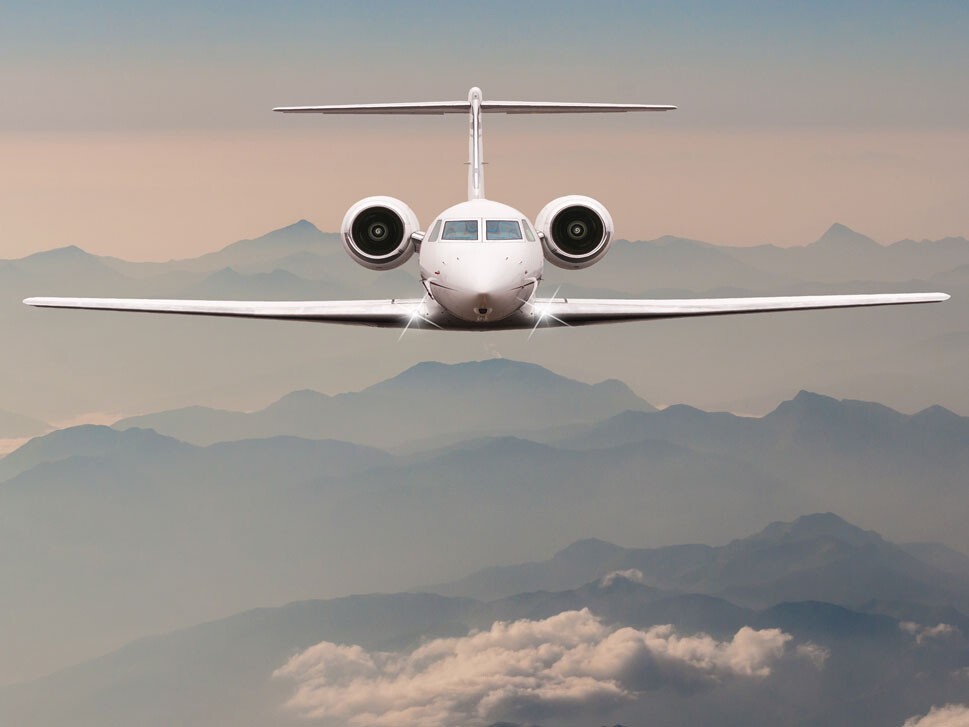 Private jet in flight front angle