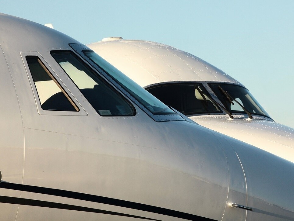 Private jet and turboprop parked next to each other