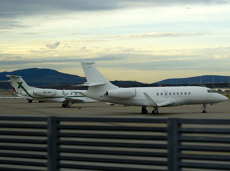 Private jets parked together on an airport apron