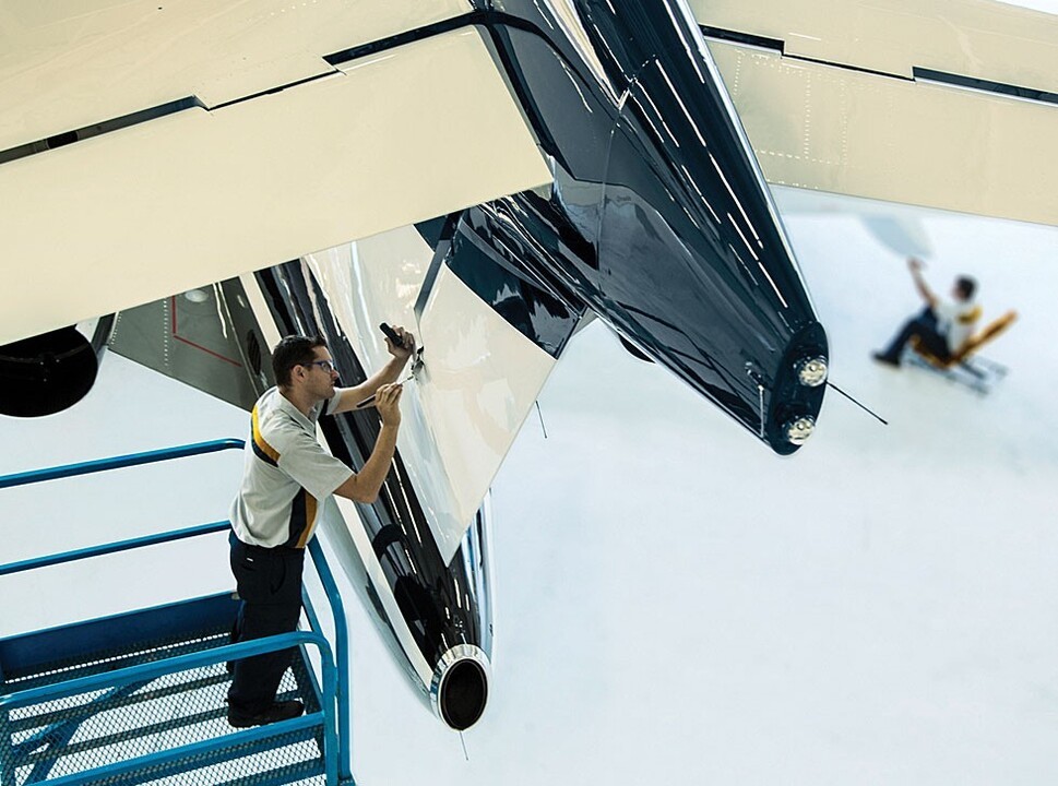 Bombardier private jet mechanic working on a Global jet