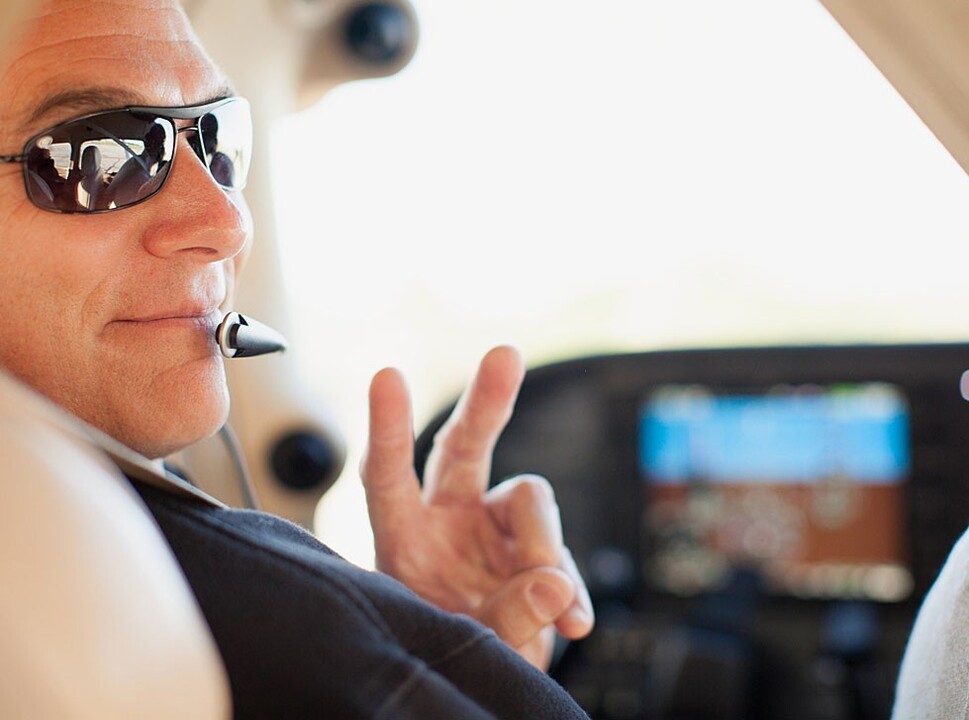 A private pilot gesturing to passengers