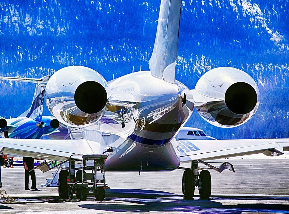 Airplane parked on crowded airport ramp