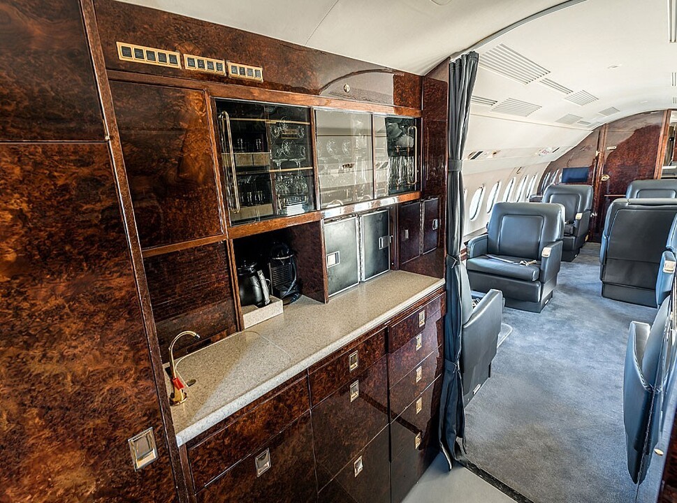 A view of a private jet cabin from the galley area