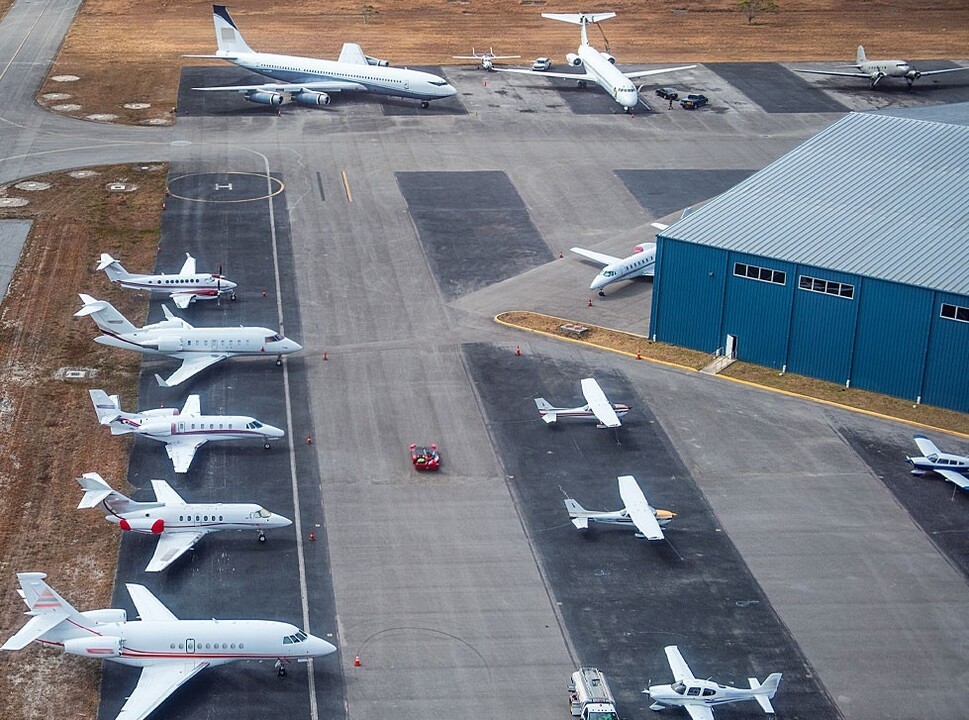 Private airplanes parked in rows at airport