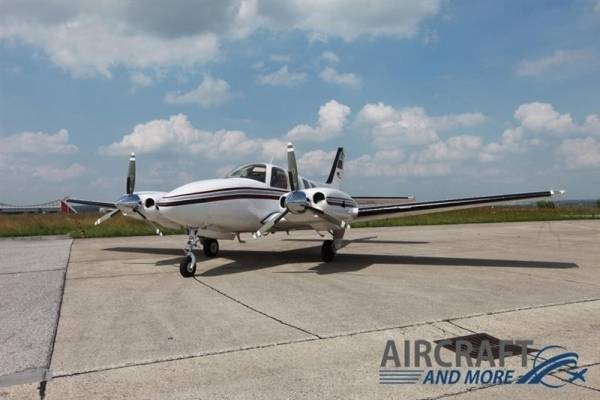 1980 beechcraft 58p baron parked on concrete nose forward white fuselage with black stripes