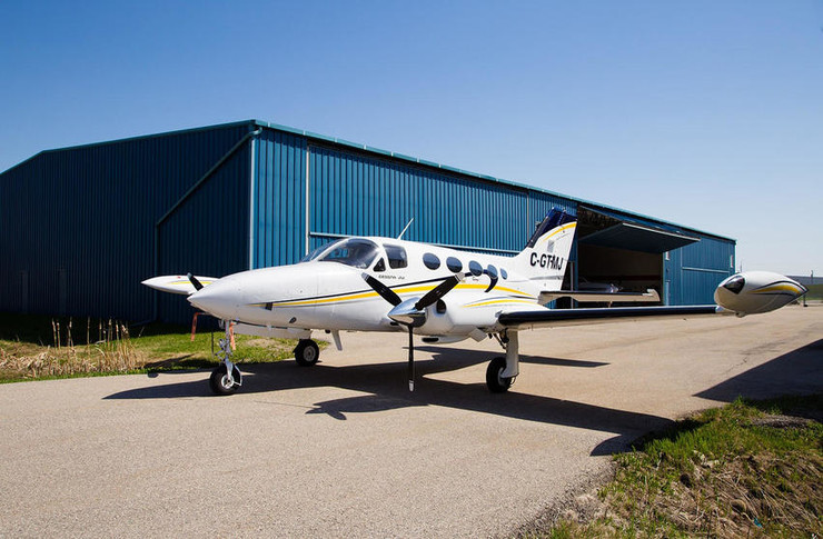 1974 cessna 414 parked outside hangar